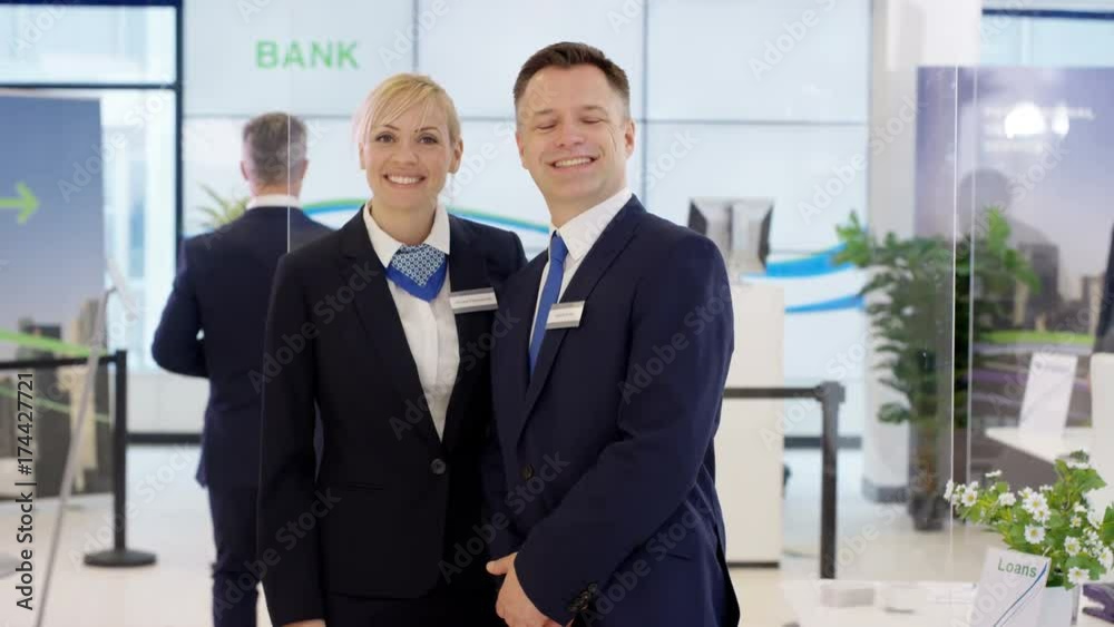 Portrait of friendly smiling customer service staff at work in bank Portrait of friendly smiling customer service staff at work in bank