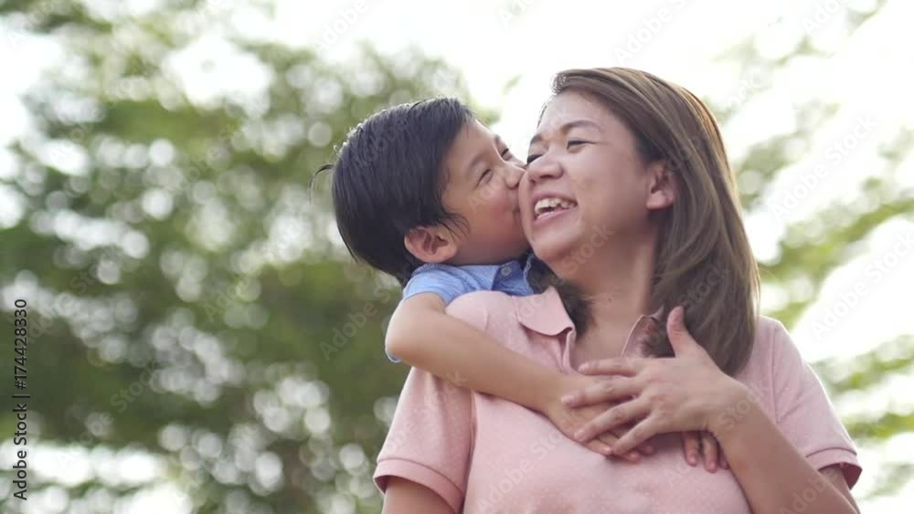 Asian child on a piggy back ride with her mother,slow motion1 Asian child on a piggy back ride with her mother,slow motion1