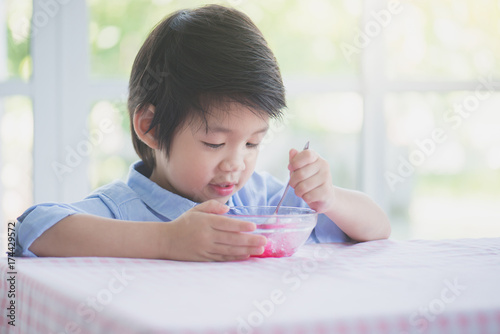 little asian child eating Shaved ice