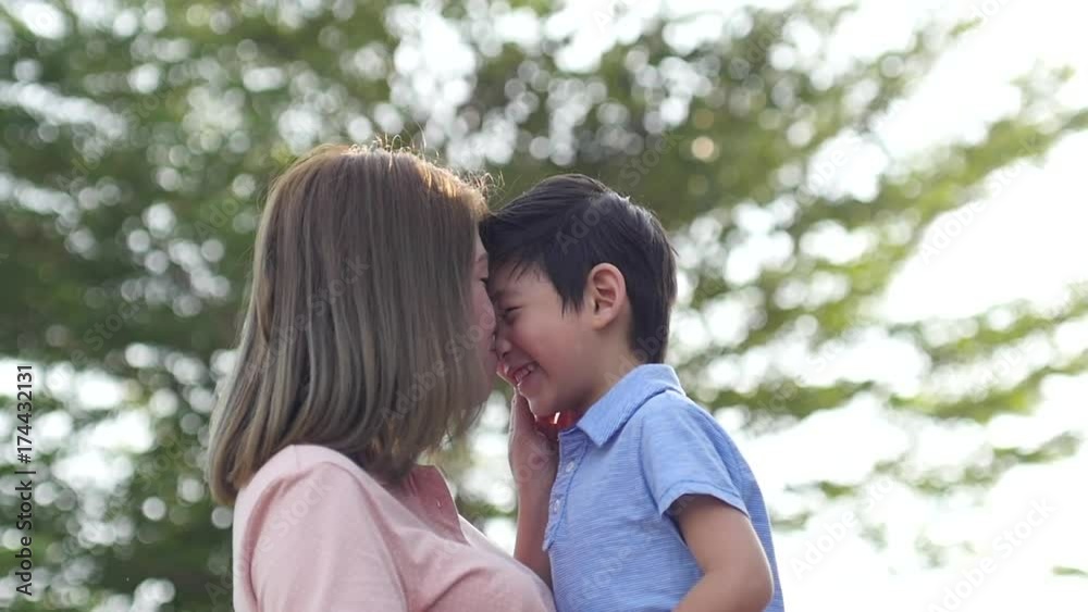 Asian mother and her son playing in the park,slow motion2