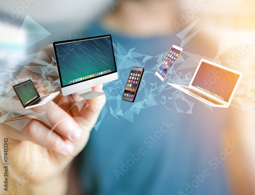 Computer and devices displayed on a futuristic interface - Multimedia and technology concept