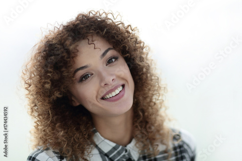 Portrait of a beautiful young woman with curly hair.