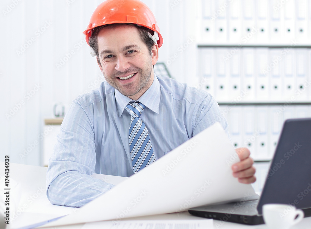 Architect looking working in office at desk. Architect looking working in office at desk.