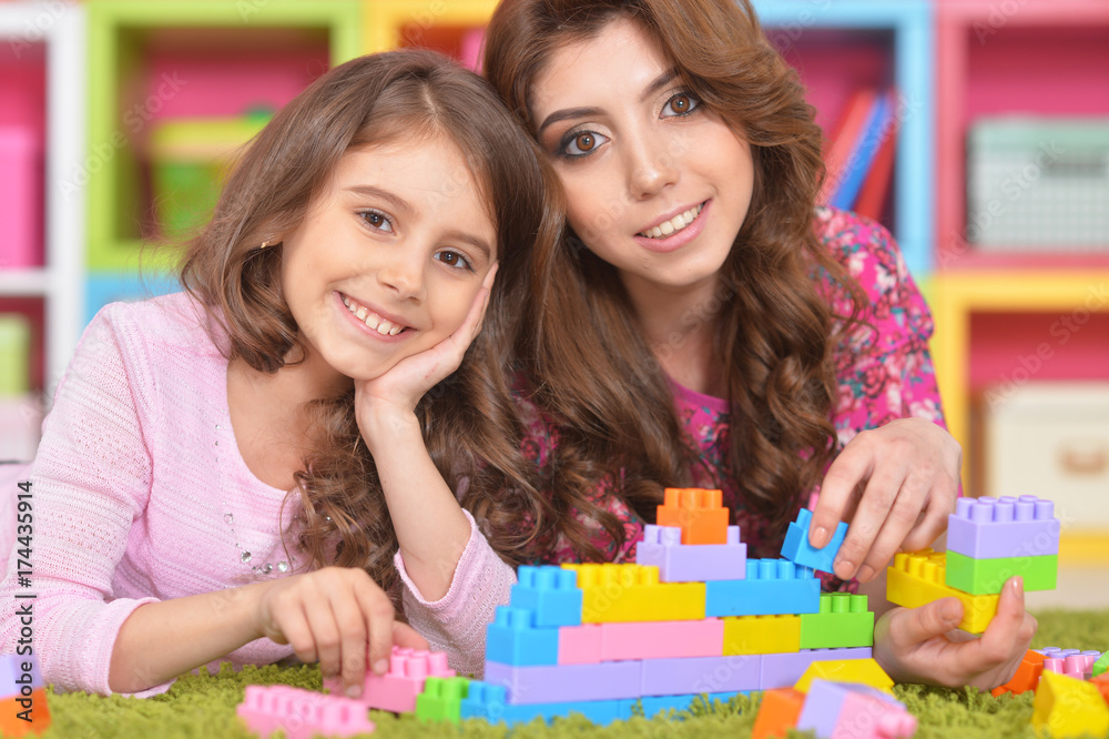 little girl playing with mother
