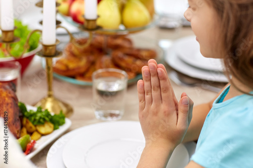 close up of girl having dinner and praying at home