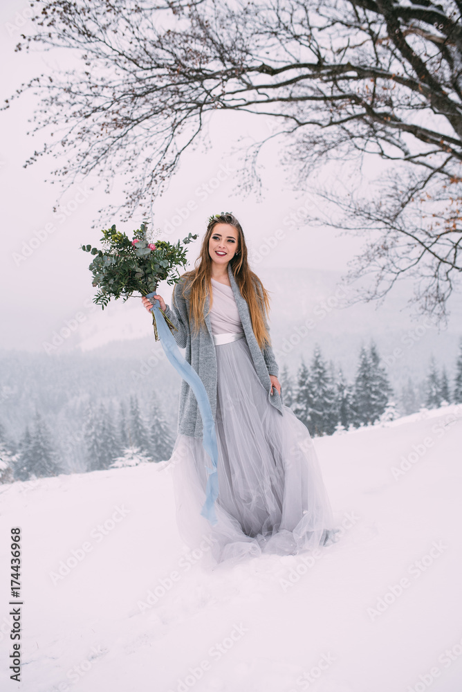 Beautiful winter portrait of young woman in the winter snowy scenery. Beautiful winter portrait of young woman in the winter snowy scenery.