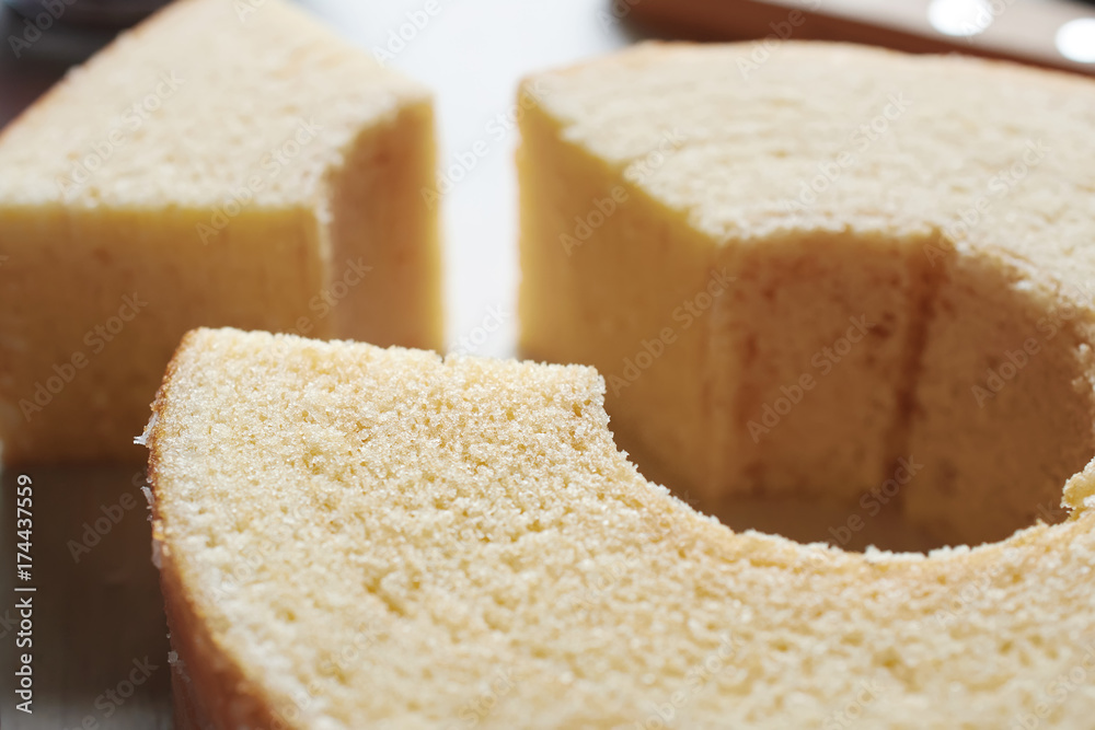 Close-up of traditional Japanese layered sponge cake with hole in the middle. Soft focus. 