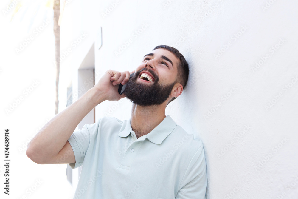 Close up handsome man standing outside and talking on mobile phone Close up handsome man standing outside and talking on mobile phone