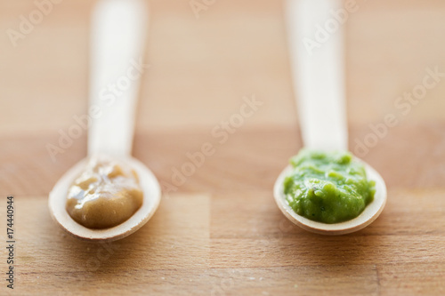vegetable or fruit puree or baby food in spoons