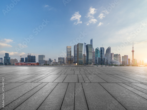 cityscape and skyline of shanghai from empty brick floor. © hallojulie