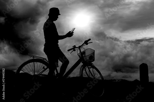 Silhouette of a man on bike,dark background.