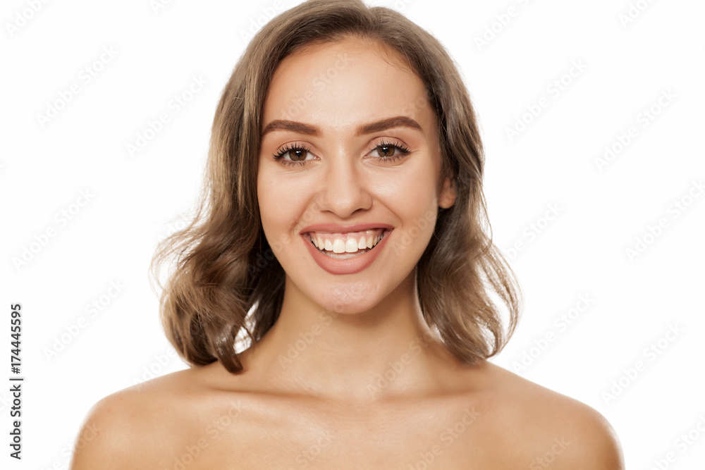 Portrait of beautiful young smiling woman on white background Portrait of beautiful young smiling woman on white background