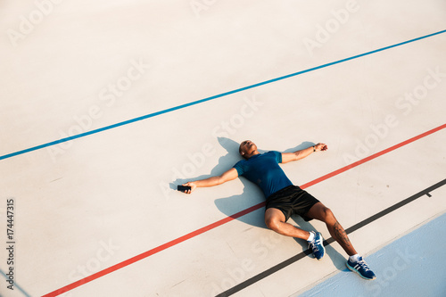 Top view portrait of an exhausted young african fitness man