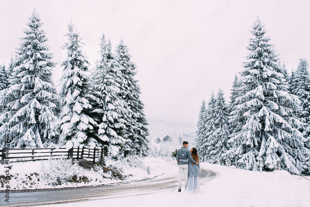 Young pretty pair of lovers. Winter. Date. A pair of lovers on a date in the mountains. Young pretty pair of lovers. Winter. Date. A pair of lovers on a date in the mountains.