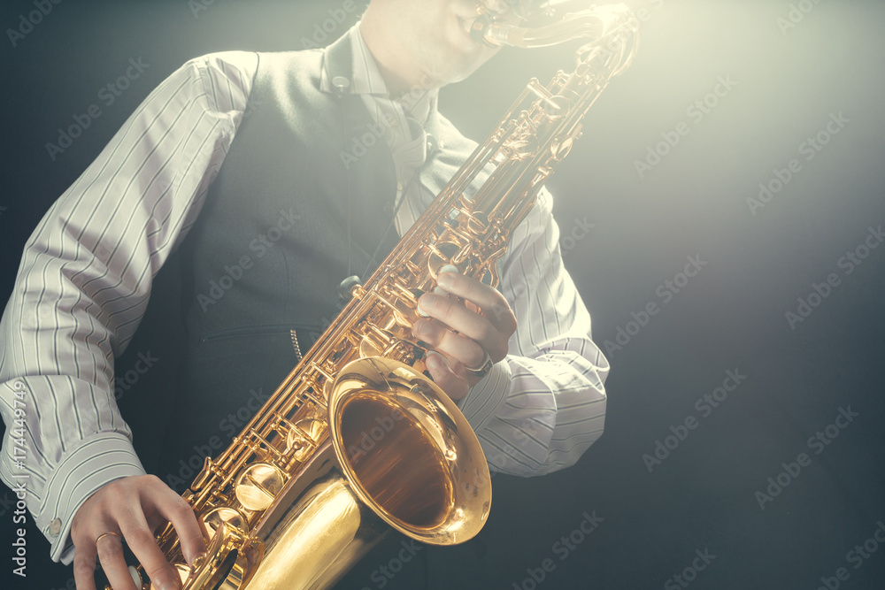 Fototapeta premium Young man playing the Saxophone