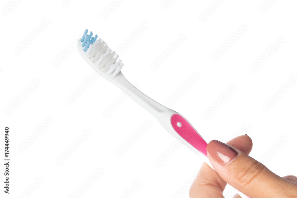 Woman hand holding a toothbrush isolated on white