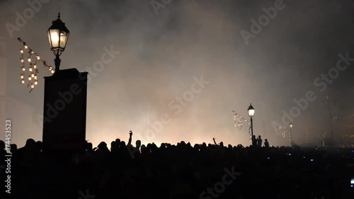 People silhouettes at night during Luminara show. Luminara is a light festival along city streets. photo