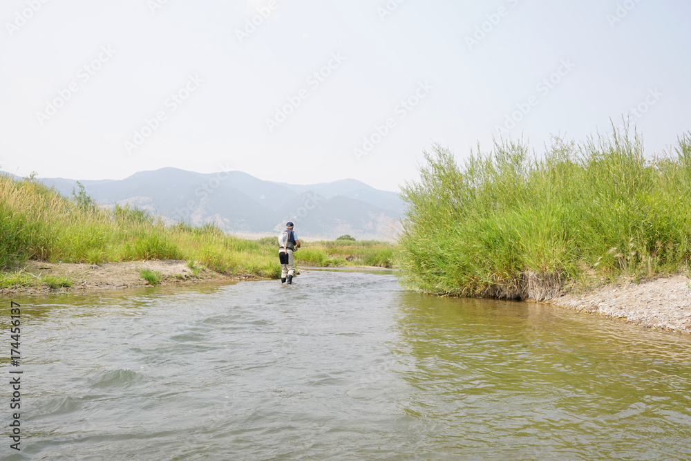 Fly fisherman fishing in river of Montana state Fly fisherman fishing in river of Montana state