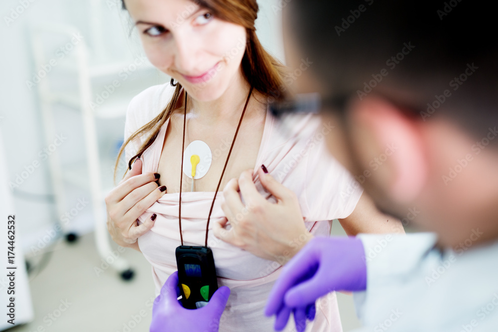 Electrodes Holter monitoring on the chest of a beautiful woman. Stock