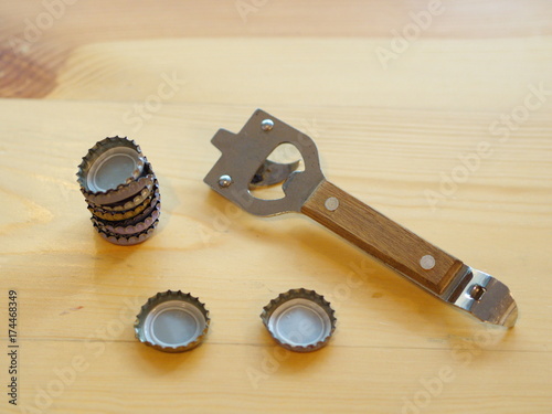 Bottle Opener with a cap on a wooden table. Natural Light.