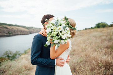 Bride and groom walking on the glade