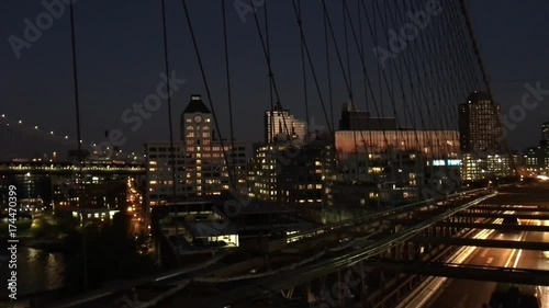 Car Night Traffic over Brooklyn Bridge with Manhattan Bridge on background.