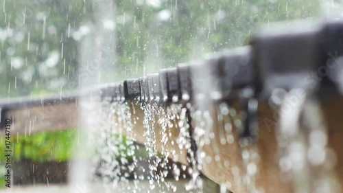 Rain drops fall continuously from a roof in the rainy season