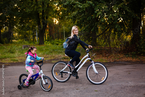Mother and daughter were cycling at the park