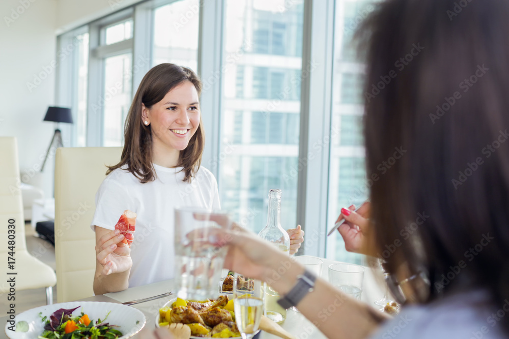 Happy smiling woman having dinner with friends Happy smiling woman having dinner with friends
