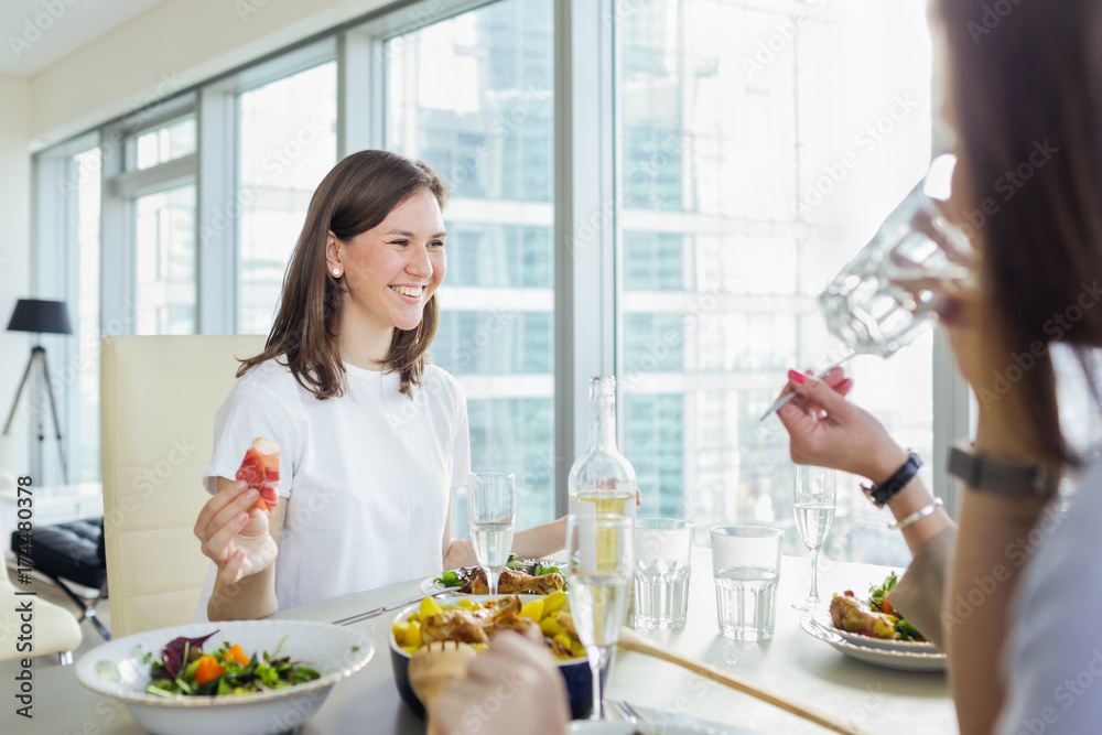 Happy smiling woman having dinner with friends Happy smiling woman having dinner with friends
