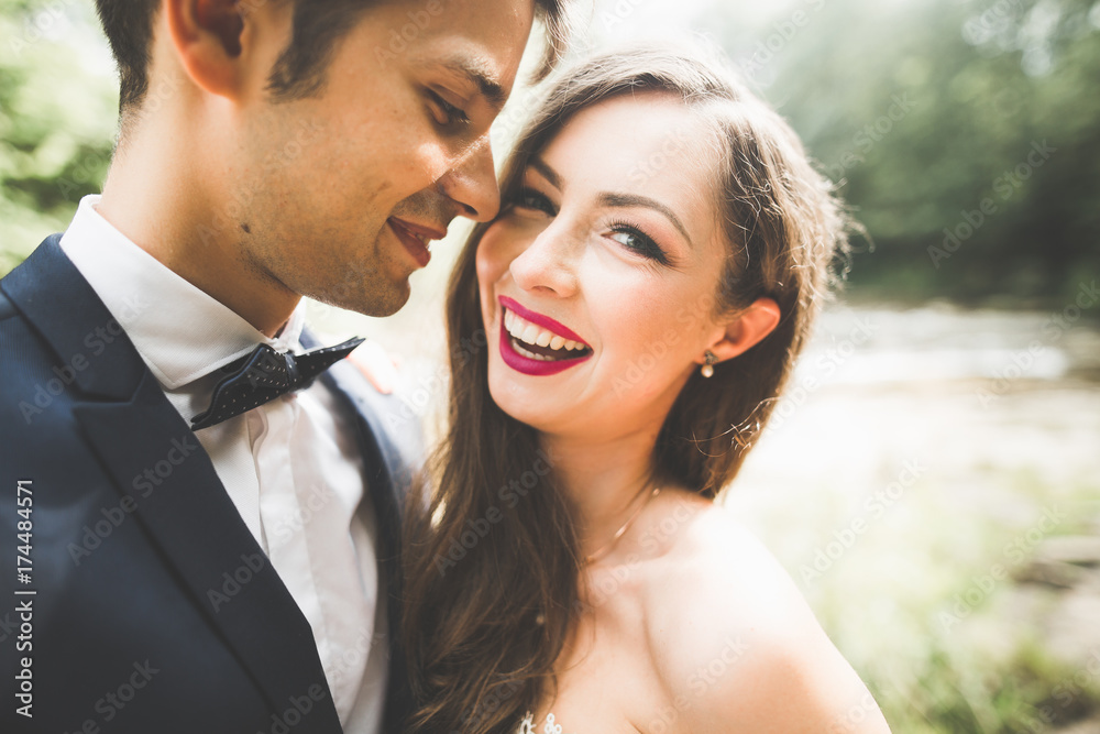 Beautiful, perfect happy bride and groom posing on their wedding day. Close up portrait Beautiful, perfect happy bride and groom posing on their wedding day. Close up portrait