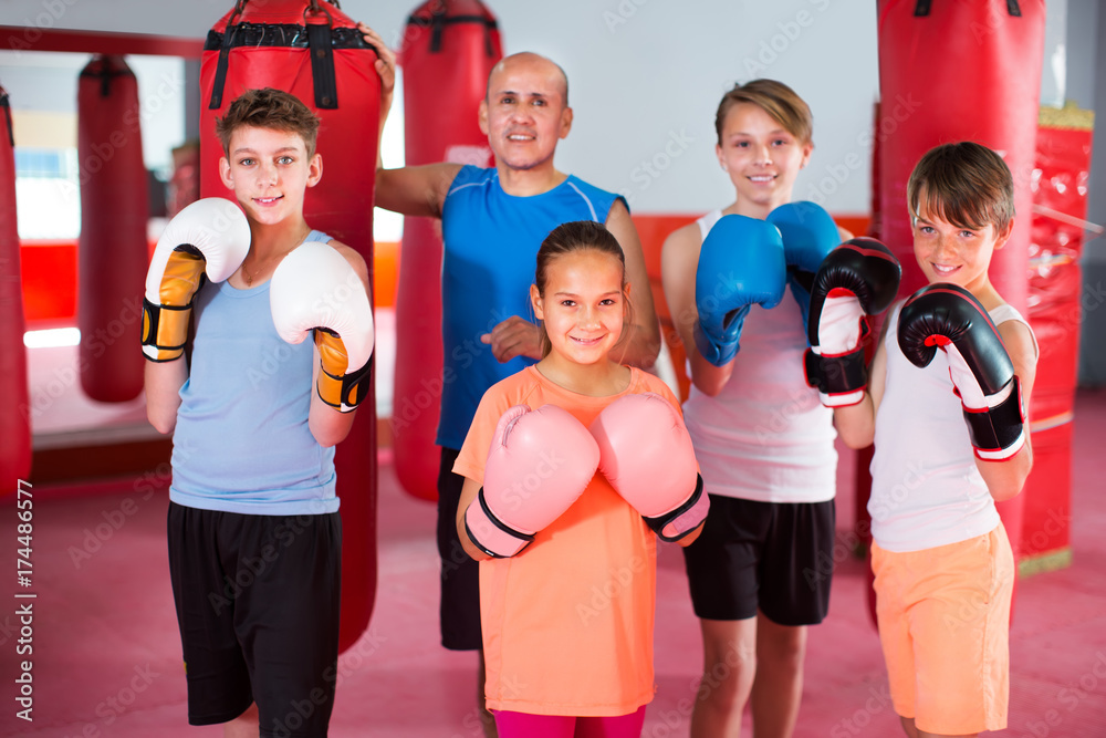 Team of boxers with a coach is happy with the training