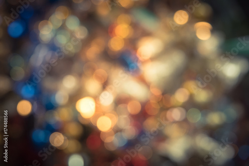 Defocused Christmas city night colorful bokeh abstract for sparkle holiday background. Vintage tone texture.