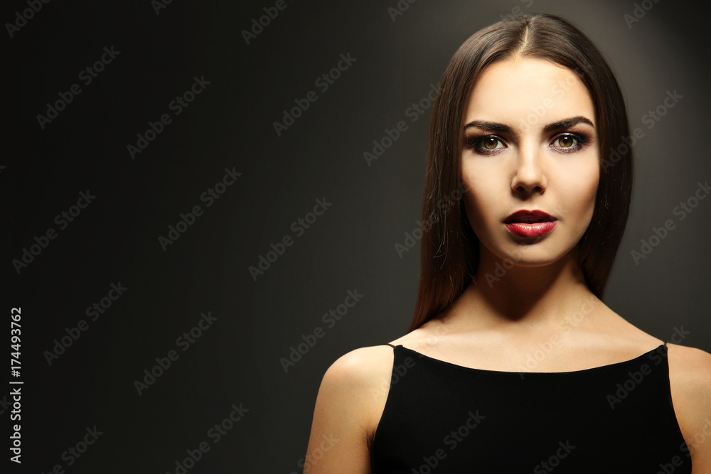 Portrait of beautiful young woman model with bright makeup on dark background Portrait of beautiful young woman model with bright makeup on dark background