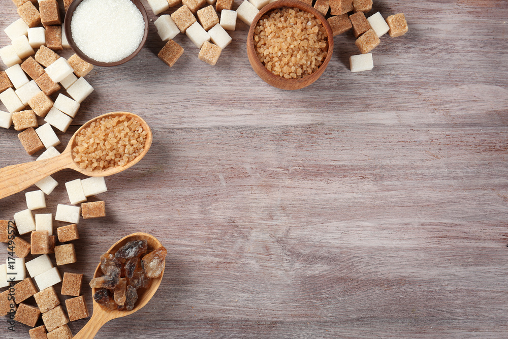 Different kinds of sugar on wooden table