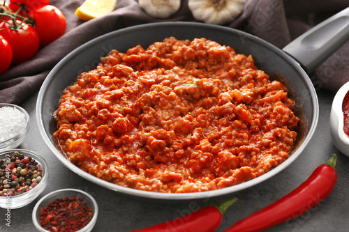 Meat sauce in frying pan on kitchen table