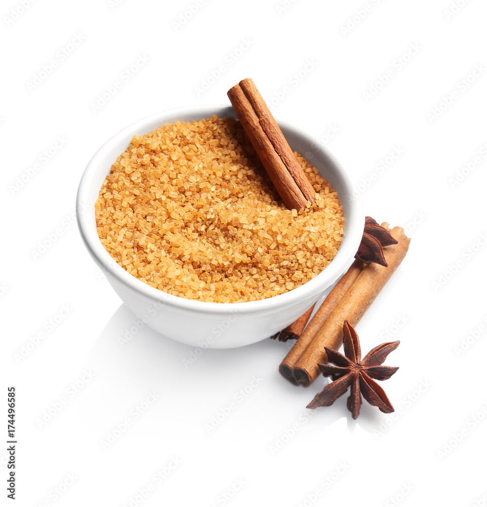 Bowl with cinnamon sugar and sticks on white background Bowl with cinnamon sugar and sticks on white background