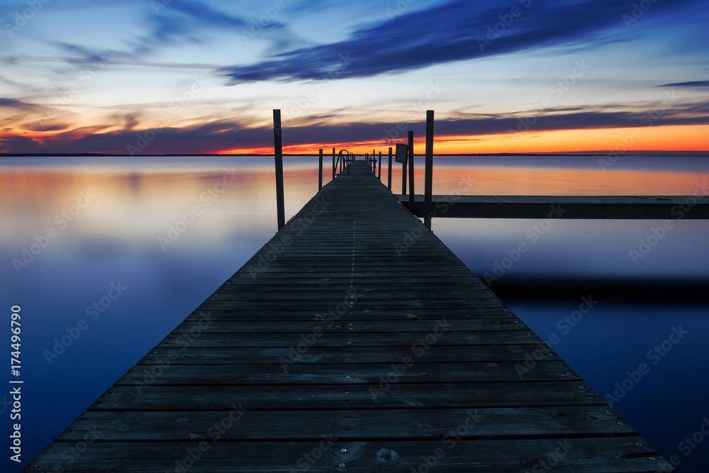 Landing stage by the sea at sunset