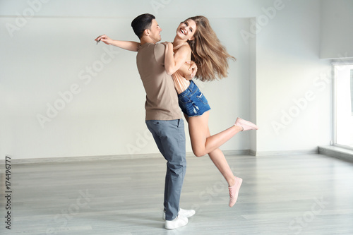 Young couple dancing in their new house