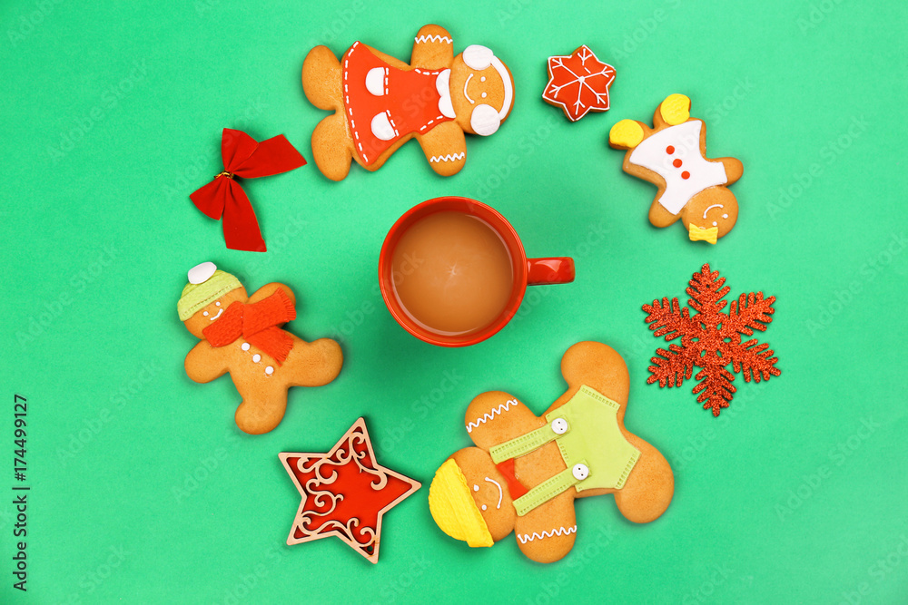 Obraz premium Tasty Christmas homemade cookies and cup of coffee on color background