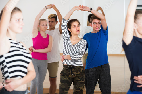 Couple of teens having dancing class indoors