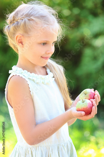 Cute little girl with apple...