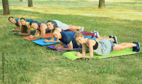 Young sporty people doing e...