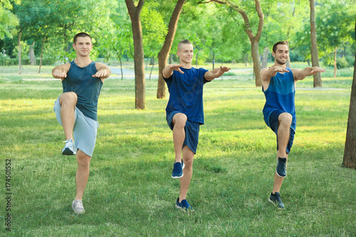 Young sporty men doing exer...