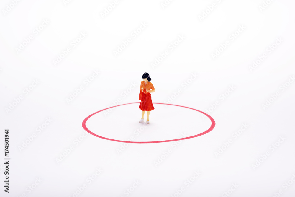 miniature pople woman in red circle over white backdrop or background.