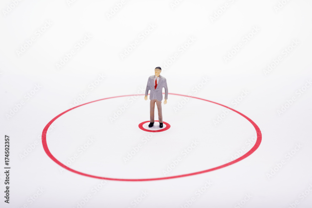 Miniature business man in red circle over white backdrop or background. Miniature business man in red circle over white backdrop or background.
