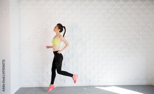 Girl in a yellow swimsuit in the gym teaches yoga for a healthy life. Exercise for every day