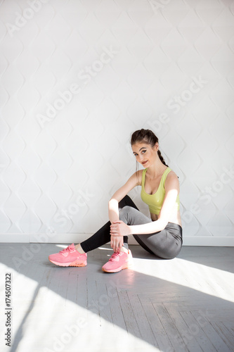 Girl in a yellow swimsuit in the gym teaches yoga for a healthy life. Exercise for every day