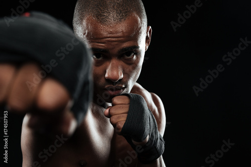Close-up photo of afroamerican boxer, showing his fists