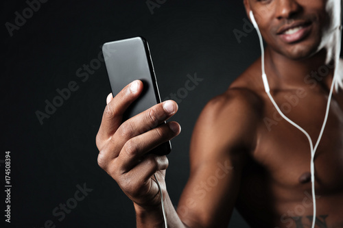 Cropped photo of handsome afro american man chatting while listen to music